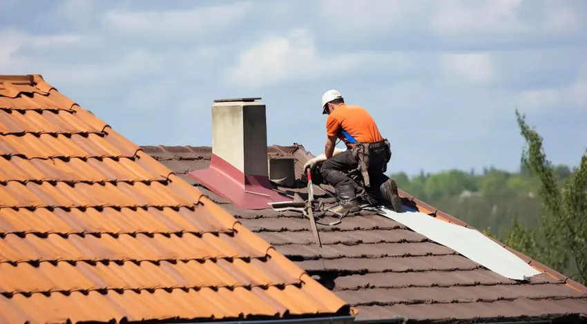 Worker Repairing Residential Roof