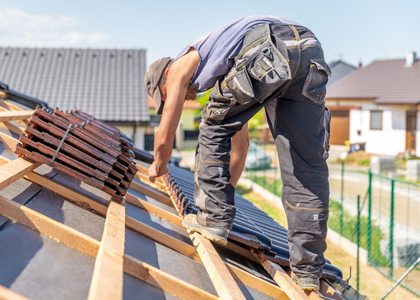 Professional roofers installing shingles on Dallas home